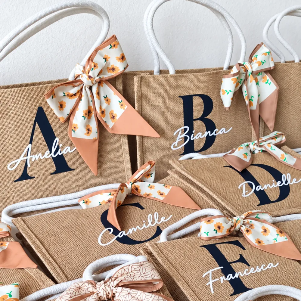 Personalized abaca tote bags with guests' initials, names and satin bows