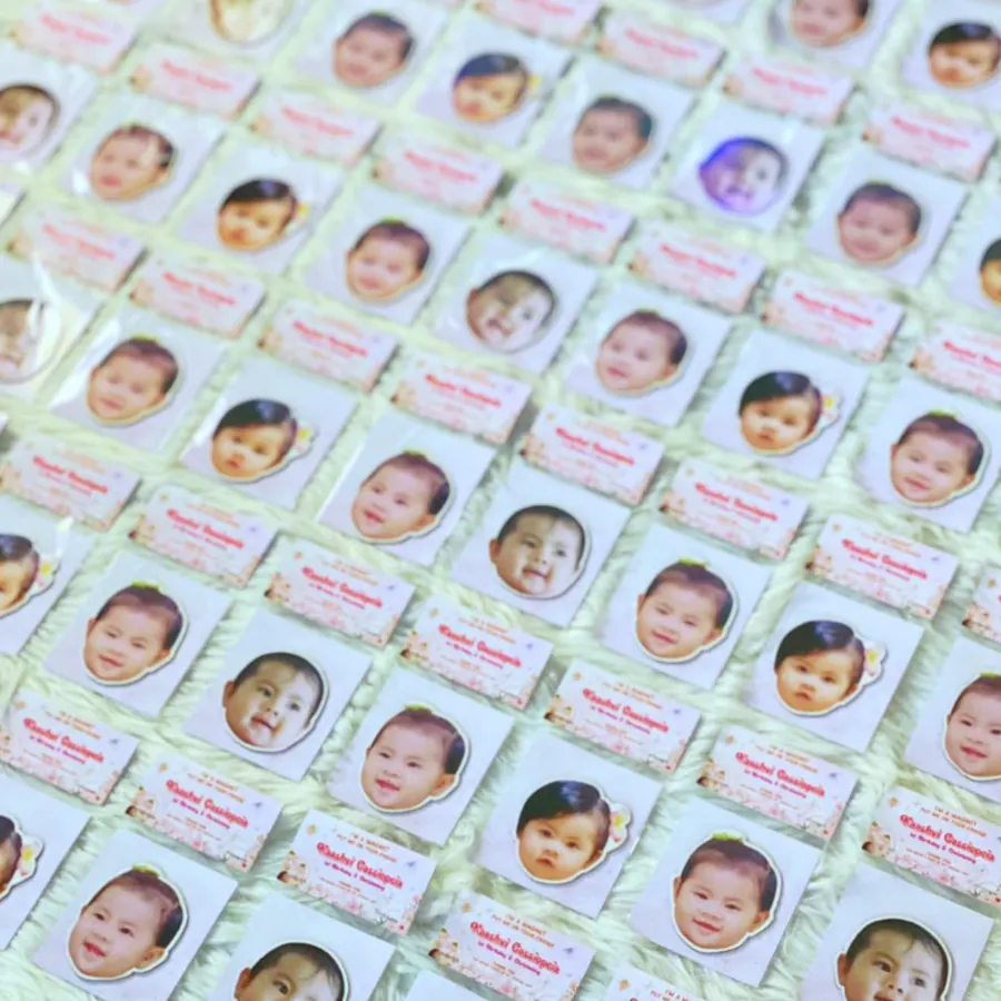 Rows of personalized photo ref magnets laid out for a big order